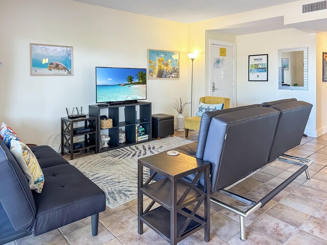 living room featuring a textured ceiling and visible vents