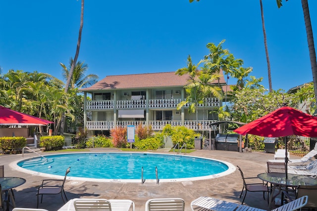 pool with a patio and fence