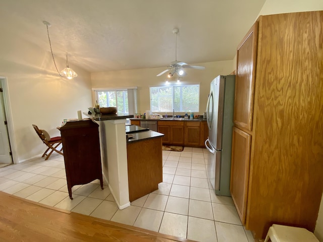 kitchen featuring light tile patterned floors, ceiling fan with notable chandelier, sink, and appliances with stainless steel finishes