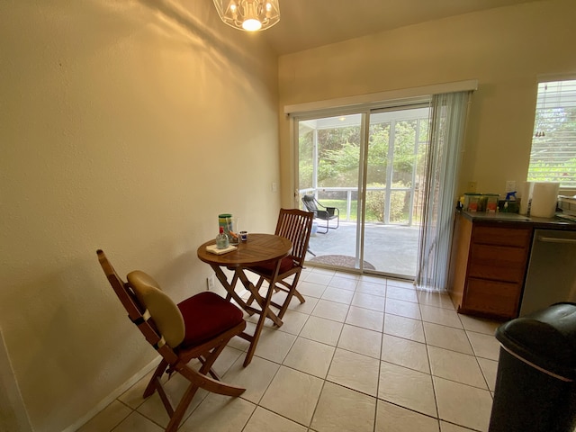 dining area with light tile patterned floors and a chandelier