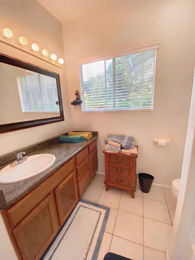 bathroom featuring vanity, toilet, and tile patterned flooring