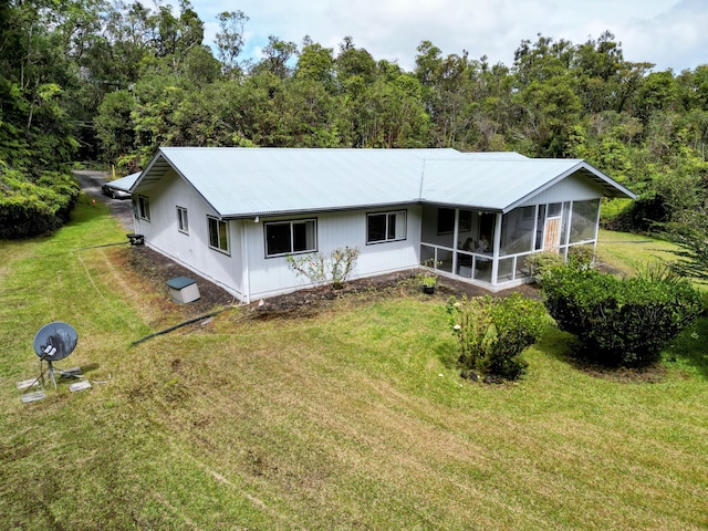 back of property featuring a sunroom and a yard