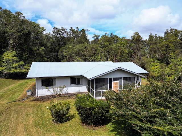 view of front of property with a sunroom and a front yard