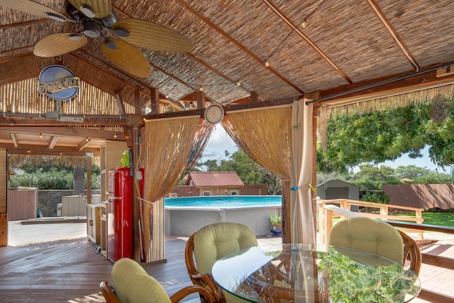 exterior space featuring ceiling fan and lofted ceiling