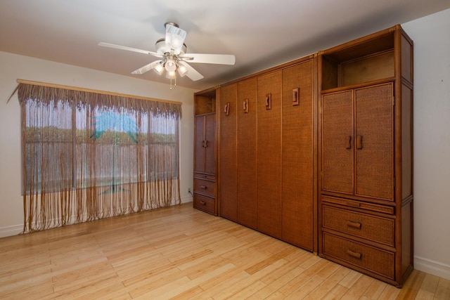 unfurnished bedroom featuring ceiling fan and light wood-type flooring