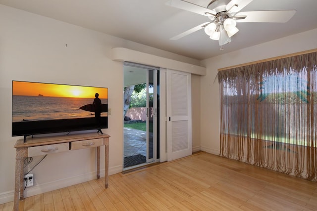 living room with hardwood / wood-style floors and ceiling fan