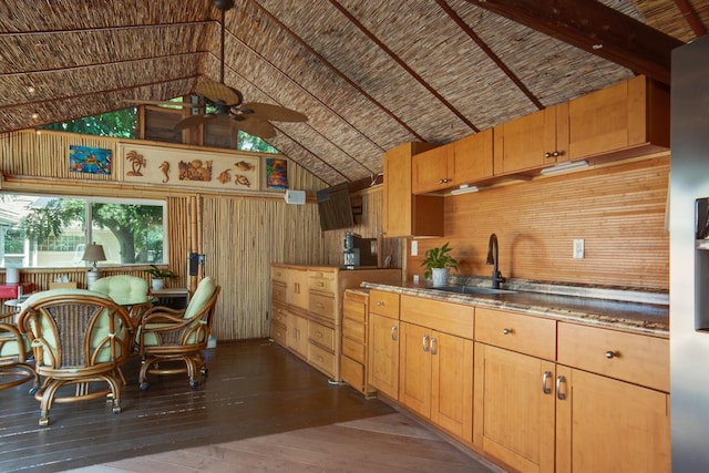 kitchen featuring ceiling fan, lofted ceiling, sink, and dark hardwood / wood-style floors