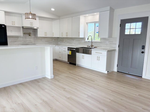 kitchen with hanging light fixtures, vaulted ceiling, black appliances, and white cabinets