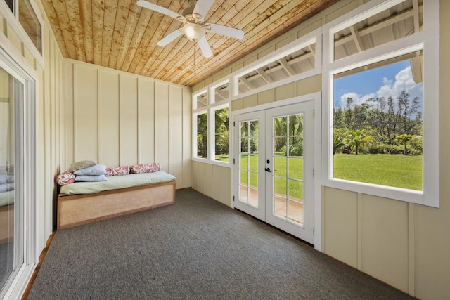 unfurnished sunroom with french doors, wood ceiling, and a ceiling fan