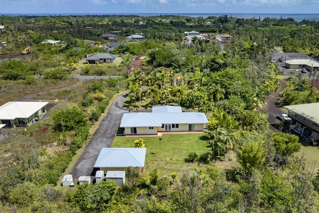 bird's eye view featuring a forest view and a water view