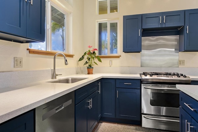 kitchen featuring a sink, stainless steel appliances, blue cabinetry, and light countertops