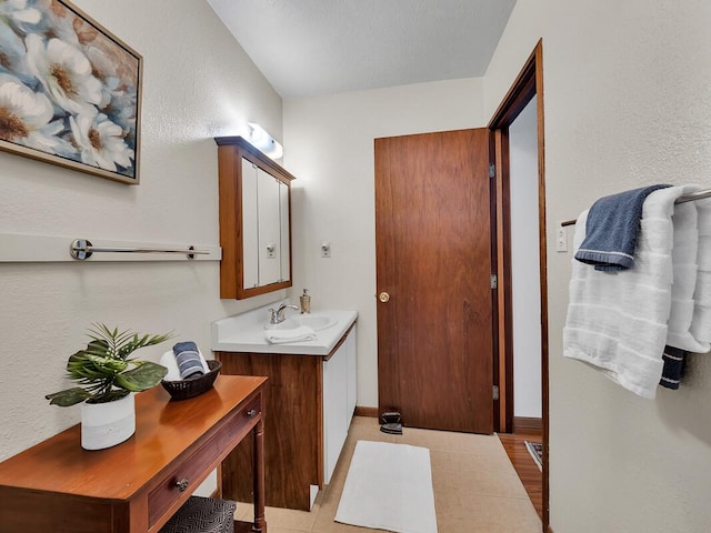 bathroom with vanity and baseboards