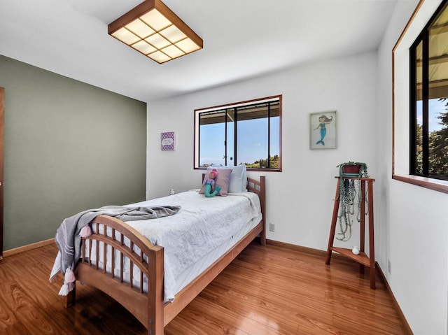 bedroom with wood finished floors and baseboards