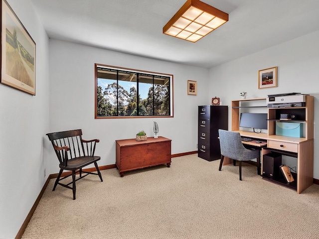 office area featuring light carpet and baseboards