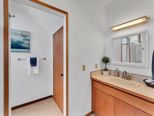 bathroom with tile patterned flooring, baseboards, and vanity