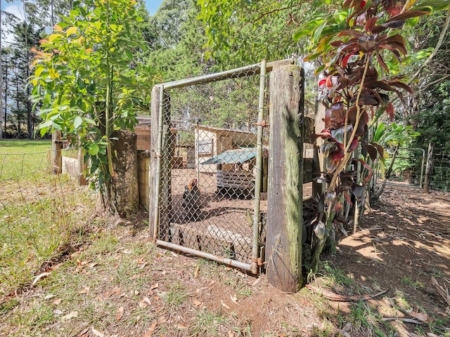 view of outbuilding with fence and an outdoor structure