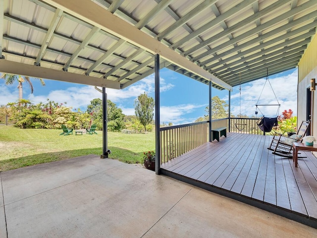 wooden deck featuring a lawn and a patio area