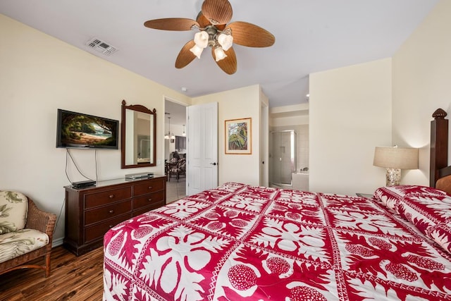 bedroom featuring dark wood-style floors, ensuite bath, visible vents, and ceiling fan