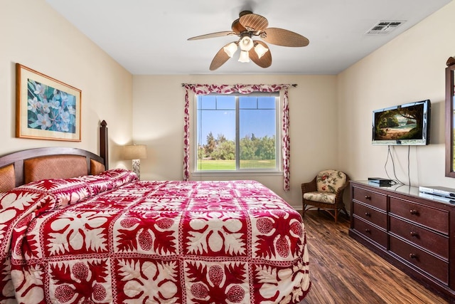 bedroom with ceiling fan, dark wood finished floors, and visible vents