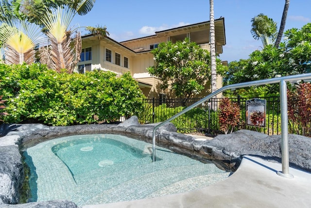 view of swimming pool with fence