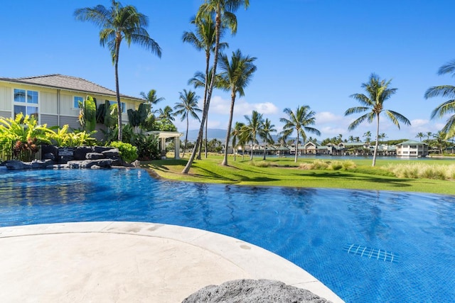 view of swimming pool featuring a yard