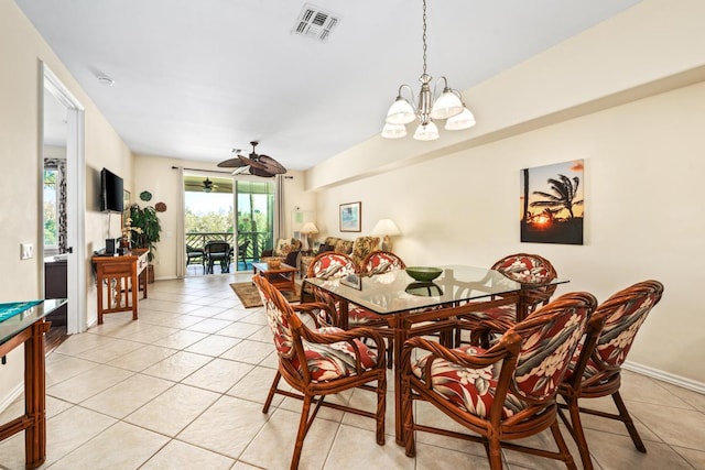 dining space with ceiling fan with notable chandelier, visible vents, baseboards, and light tile patterned floors