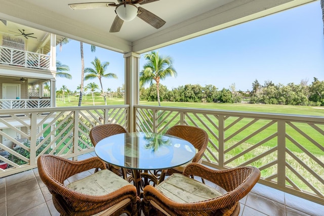 sunroom with a healthy amount of sunlight and ceiling fan