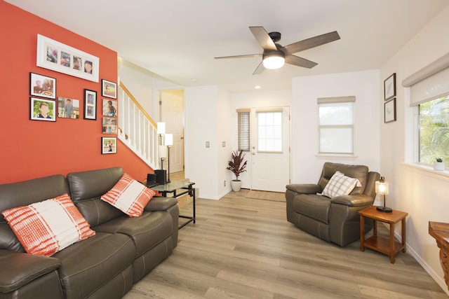 living room featuring light hardwood / wood-style floors and ceiling fan