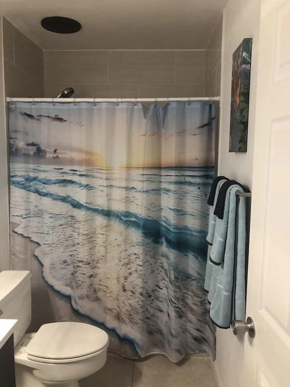 bathroom with vanity, walk in shower, tile patterned floors, and toilet