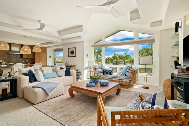 living room featuring a tray ceiling and ceiling fan