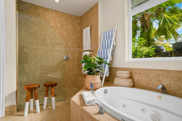 bathroom with independent shower and bath and tile patterned floors