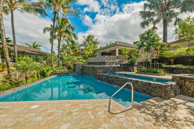 view of pool with pool water feature, a jacuzzi, and a patio