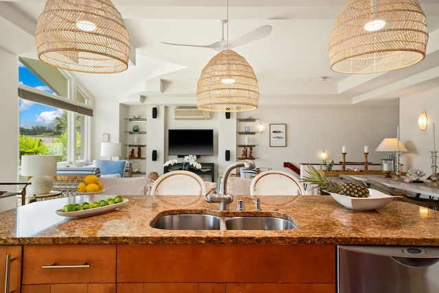 kitchen with sink, dishwasher, hanging light fixtures, stone countertops, and an AC wall unit