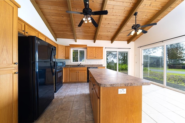 kitchen featuring tile patterned flooring, a center island, vaulted ceiling with beams, and black appliances