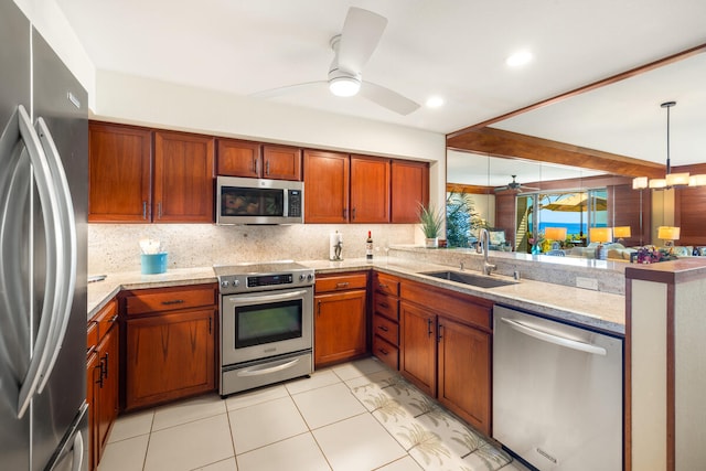 kitchen featuring tasteful backsplash, sink, ceiling fan, and appliances with stainless steel finishes