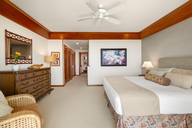 bedroom featuring crown molding, light colored carpet, and ceiling fan