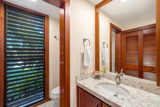 bathroom featuring vanity and toilet