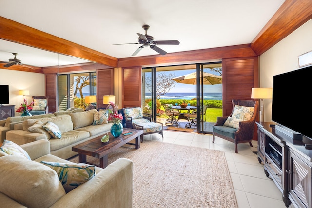 living room with beamed ceiling, light tile patterned floors, and ceiling fan