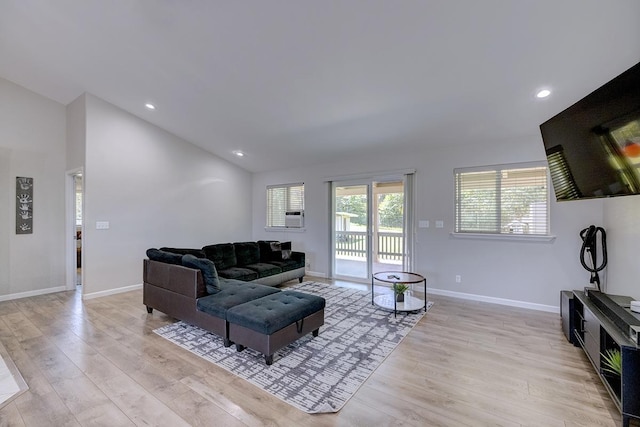 living area featuring lofted ceiling, light wood-style flooring, baseboards, and recessed lighting