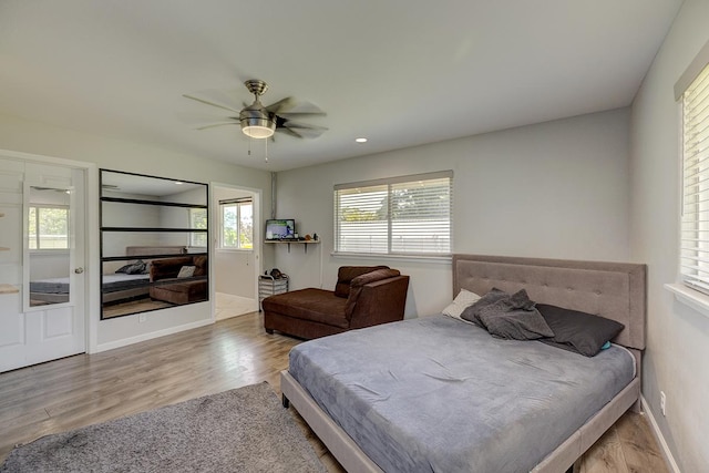 bedroom featuring ceiling fan, recessed lighting, wood finished floors, and baseboards