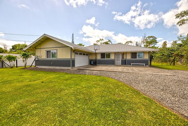 single story home with metal roof, fence, a garage, driveway, and a front lawn