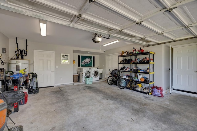 garage with washing machine and clothes dryer and a garage door opener