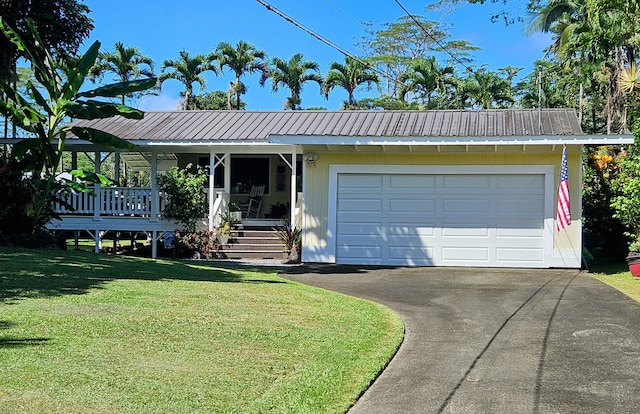 single story home featuring a porch, metal roof, a garage, driveway, and a front lawn