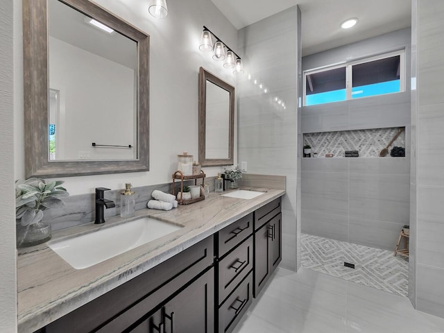 bathroom with vanity and a tile shower