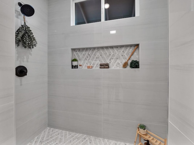 bathroom with a tile shower