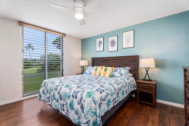 bedroom featuring dark hardwood / wood-style floors, a textured ceiling, and ceiling fan