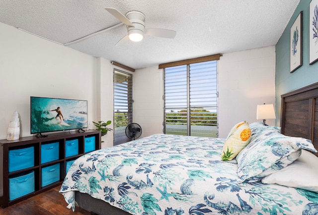 bedroom featuring ceiling fan, dark wood-type flooring, a textured ceiling, and access to outside