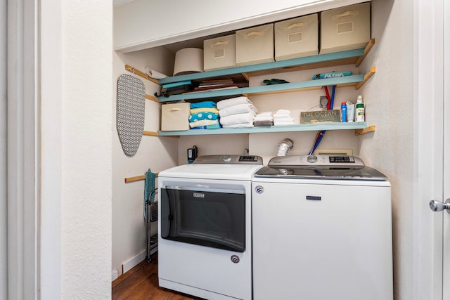 laundry room with dark hardwood / wood-style flooring and washing machine and dryer