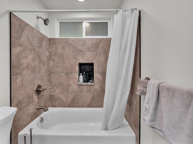 bathroom featuring toilet and shower / bath combo