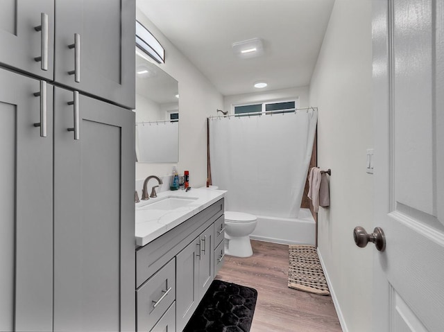 full bathroom with vanity, toilet, shower / tub combo, and wood-type flooring